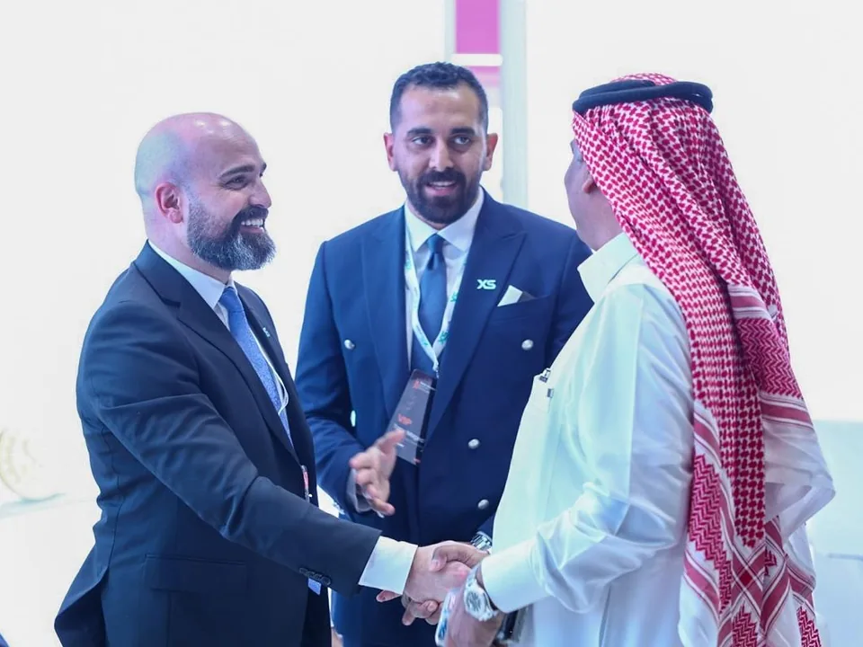Business conversation and handshake during a financial industry event