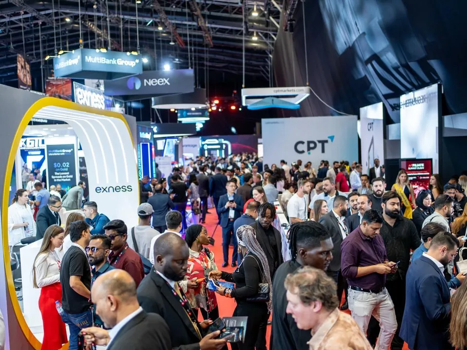 Financial professionals networking on a busy exhibition floor